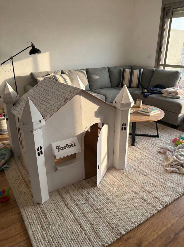 White playhouse with 'Faefold' branding in a living room setting.